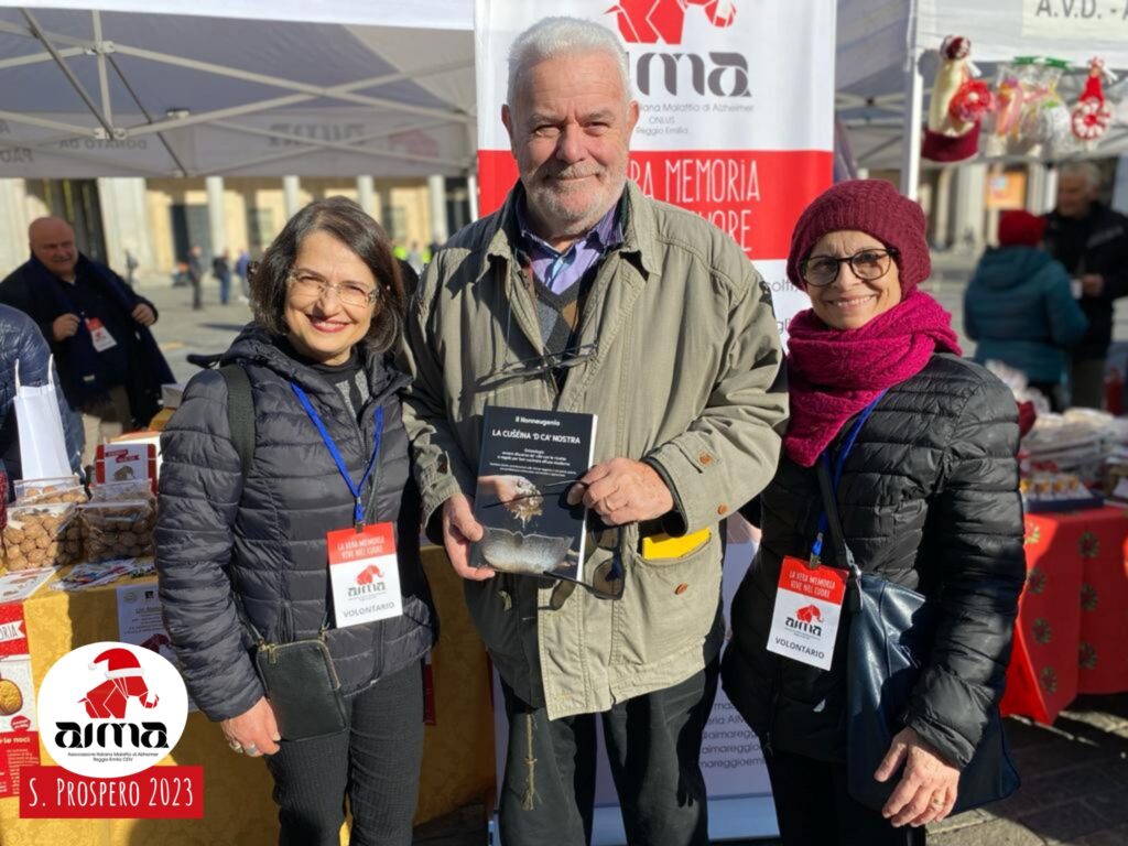 Volontarie di AIMA Reggio Emilia con Eugenio Menozzi nello stand con le Noci della Memoria in piazza Martiri nel giorno della Festa di San Prospero, 24 novembre 2023